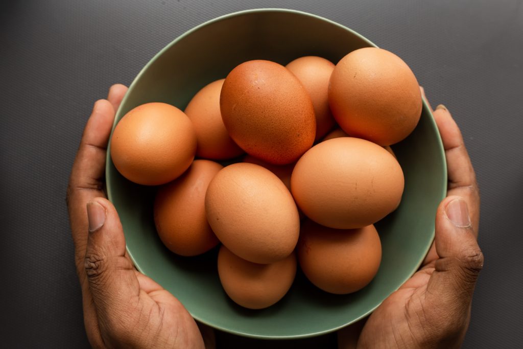 a green bowl full of brown eggs. eggs are just one food that boosts brainpower. 