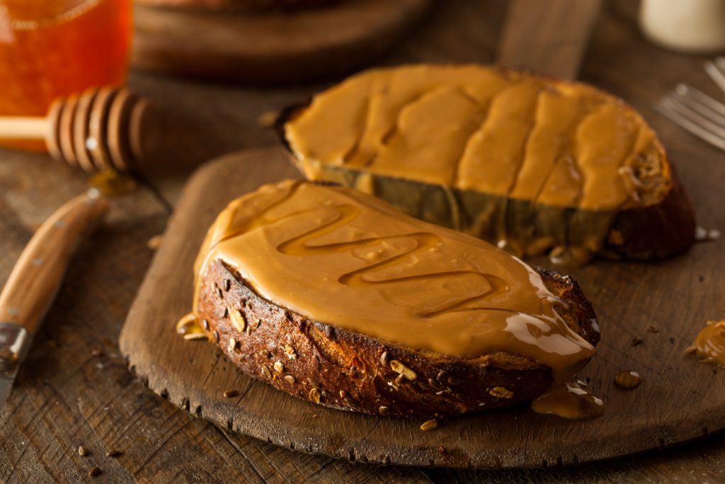 an example of carbs, an image of two slices of peanut butter toast drizzled with honey 